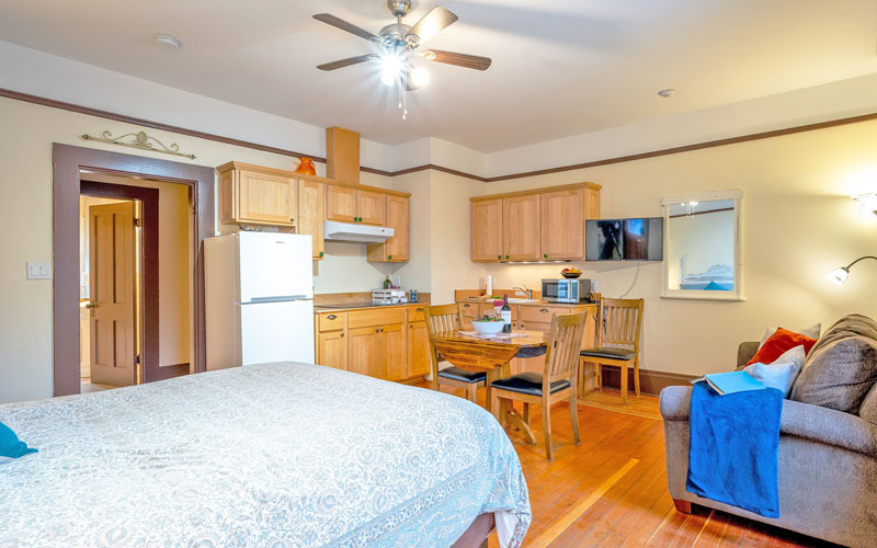 Falls-Bachler-Suite-at-Victoria-Falls-House-Nelson-BC Cozy studio suite with a queen bed and kitchenette in the Falls Suite at Victoria Falls House, Nelson, BC.